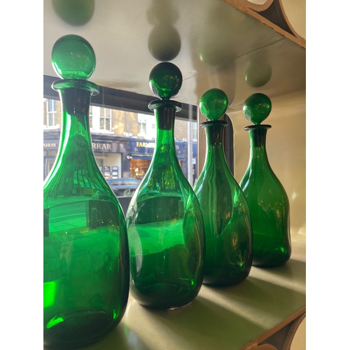 459 - 20th CenturyFour handblown green glass bottles with stoppersProperty of a noblemanDimensions:13 in. ... 