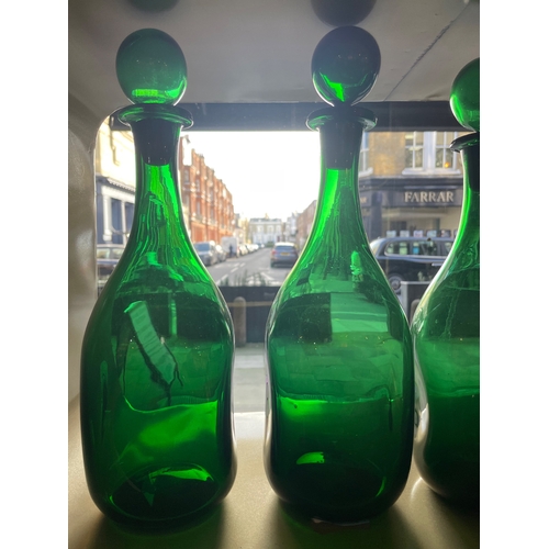 459 - 20th CenturyFour handblown green glass bottles with stoppersProperty of a noblemanDimensions:13 in. ... 