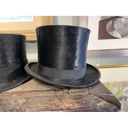 488 - 20th CenturyA group of three top hats[a] A Delicon black silk top hat[b] A Woodrow black silk top ha... 