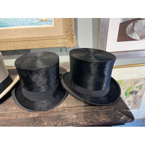 488 - 20th CenturyA group of three top hats[a] A Delicon black silk top hat[b] A Woodrow black silk top ha... 