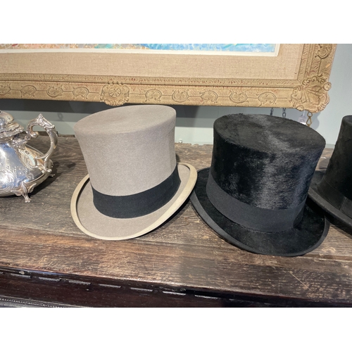 488 - 20th CenturyA group of three top hats[a] A Delicon black silk top hat[b] A Woodrow black silk top ha... 