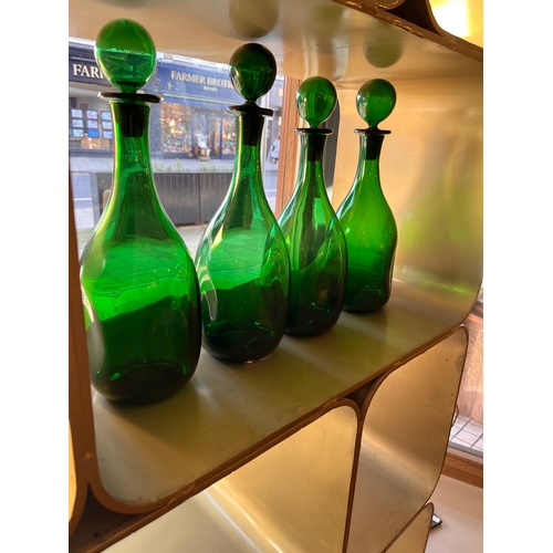 459 - 20th CenturyFour handblown green glass bottles with stoppersProperty of a noblemanDimensions:13 in. ... 