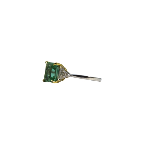 127 - BritishCirca 2000A fine Colombian emerald and diamond ringThe central rectangular emerald of excelle... 