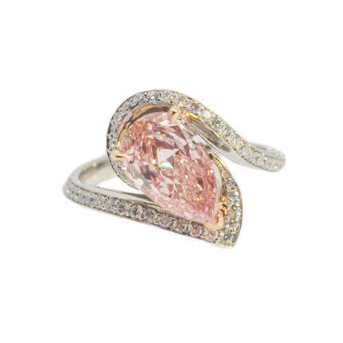 132 - BritishContemporaryA pretty pink diamond and white diamond ringThe pear-shaped central treated pink-... 