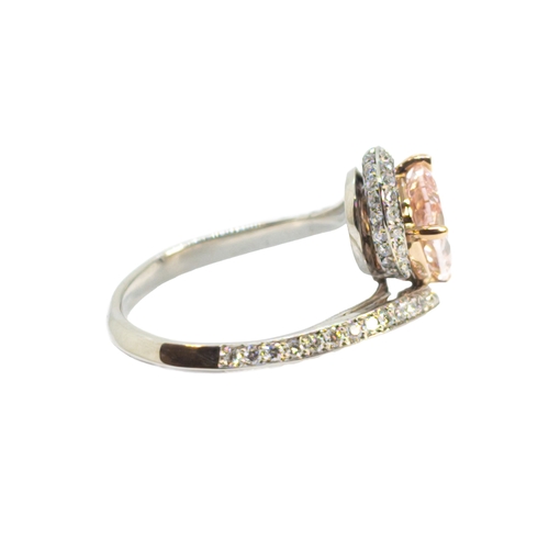 132 - BritishContemporaryA pretty pink diamond and white diamond ringThe pear-shaped central treated pink-... 