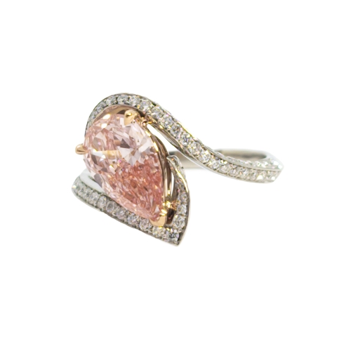 132 - BritishContemporaryA pretty pink diamond and white diamond ringThe pear-shaped central treated pink-... 