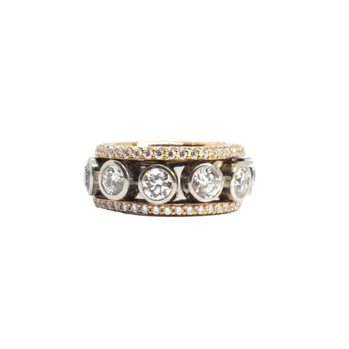 136 - BritishCirca 2000A fine quality whimsical diamond band ringComprising a line of collett-set brillian... 