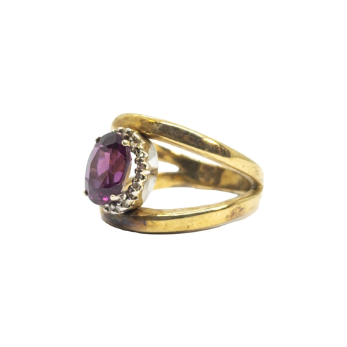 166 - BritishCirca 1980A diamond, red stone and 9 carat yellow gold dress ringWeight: Approx. 6.95 gramsRi... 