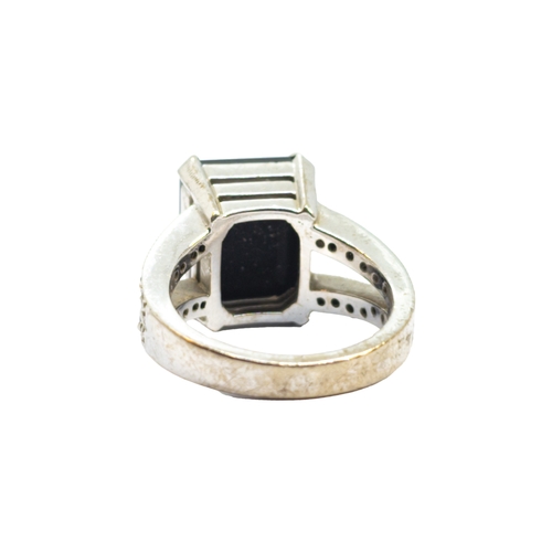 169 - BritishContemporaryAn 18 carat white gold, diamond and black gemstone dress ringWeight: Approx. 9.62... 