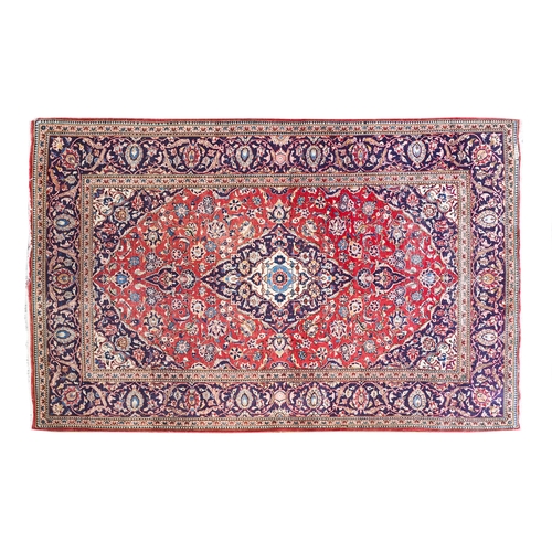 382 - 20th Century A large Persian rug in reds and blues