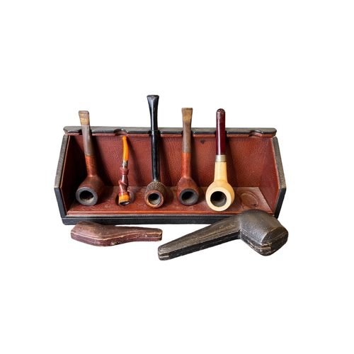 659 - 20th CenturyAn eclectic selection of objets[a] Two cut glass decanters[b] Five tobacco pipes, with a... 