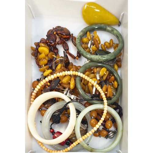 677 - European20th CenturyA mixed lot of costume jewelleryTo include amber beads, jadeite bangles, coral b... 