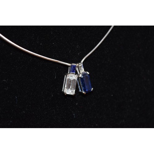 130 - ContinentalCirca 1970A fine emerald-cut diamond and sapphire pendant necklaceThe emerald-cut diamond... 