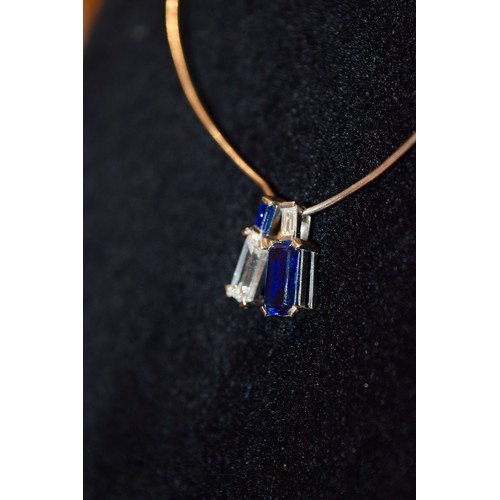 130 - ContinentalCirca 1970A fine emerald-cut diamond and sapphire pendant necklaceThe emerald-cut diamond... 