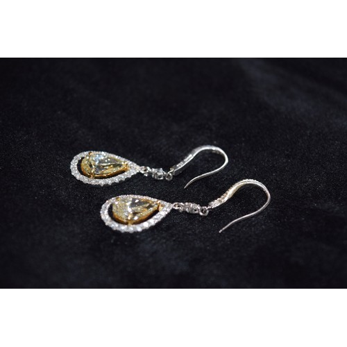 141 - BritishContemporaryA fine pair of yellow diamond and diamond drop earringsThe main pear-shaped diamo... 