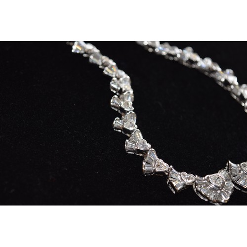 142 - BritishCirca 2000An attractive diamond necklaceComposed of heart-shaped diamond and calibré baguette... 