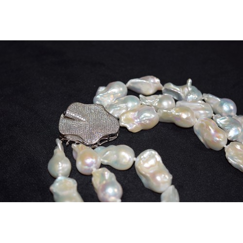 174 - ContinentalContemporaryAn impressive three-row Baroque pearl festooned necklaceWith micro-set diamon... 