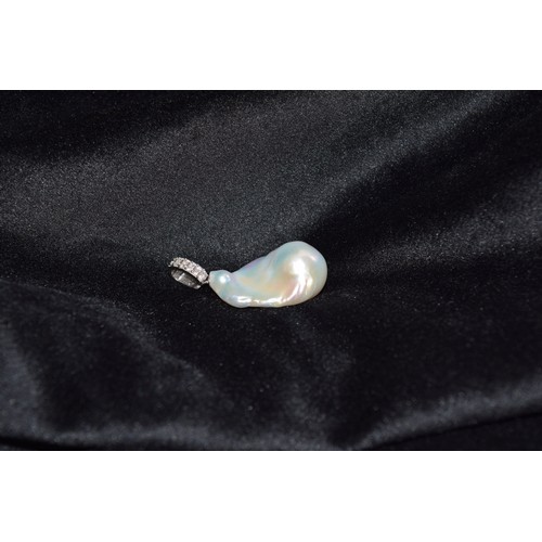 188 - EuropeanContemporaryAn irregular Baroque cultured pearl and diamond pendantThe large Baroque pearl w... 