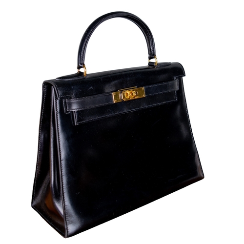 1 - HermèsCirca 1980A 28 Kelly black box leather handbagWith Hermès drawstring dust bagDimensions:12.5 i... 