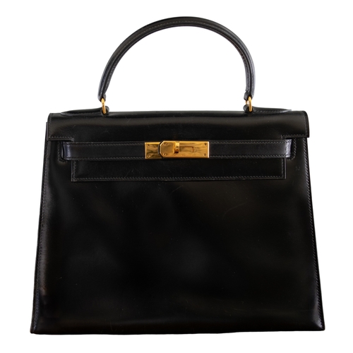 1 - HermèsCirca 1980A 28 Kelly black box leather handbagWith Hermès drawstring dust bagDimensions:12.5 i... 