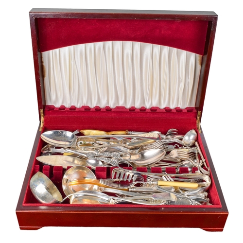 142 - British20th CenturyA wooden box of serving utensilsIncluding spoons, forks, and tongs... 