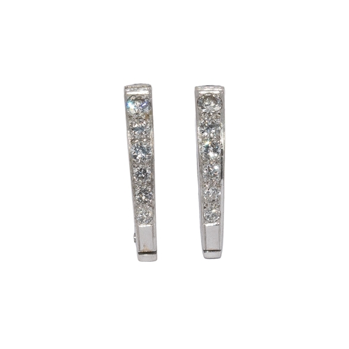 15 - AmericanCirca 1970A pair of diamond and white metal cufflinksEach link formed of a graduating row of... 