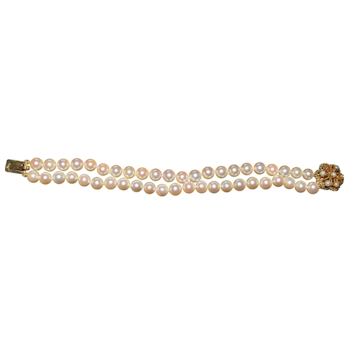 33 - BritishCirca 1970A two row cultured pearl bracelet to a gold and pearl clasp