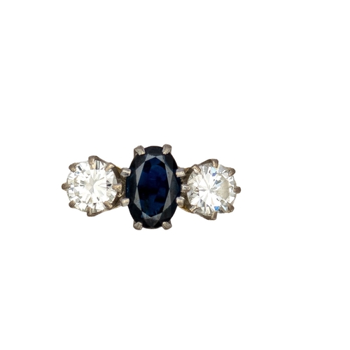 47 - BritishCirca 1950A three stone sapphire and diamond ring mounted in 18 carat yellow gold and platinu... 