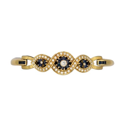 66 - ContinentalCirca 1980A diamond, sapphire and 18 carat yellow gold bangleWeight: Approx. 18.27 grams... 