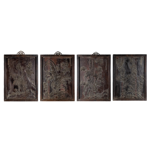 680 - ChineseCirca 1920Four carved hardwood panels depicting various floral scenes with exotic birds and m... 