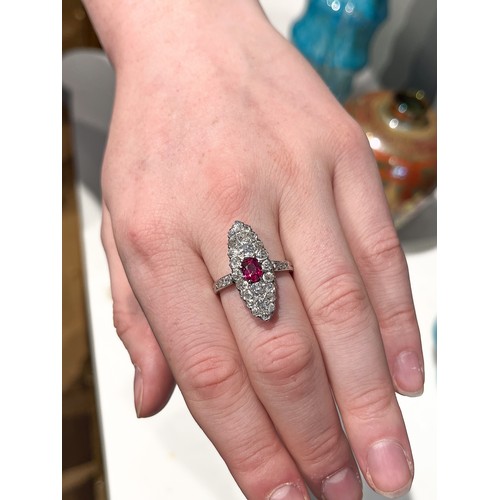 35 - FrenchArt NouveauA fine ruby, platinum and diamond ringThe navette shaped diamond cluster set to the... 