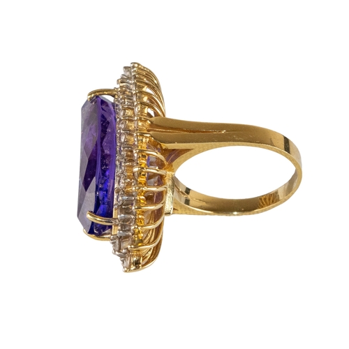 16 - AmericanCirca 1990An impressive tanzanite and diamond dress ringThe marquise shaped tanzanite weighi... 