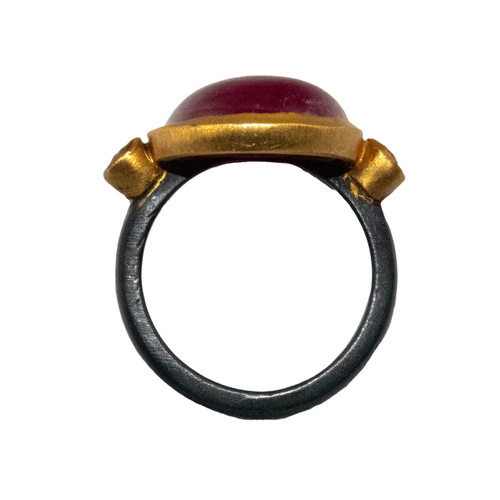 37 - Brooski, a large contemporary cabochon ruby and diamond dress ring. The oval shaped cabochon ruby wi... 