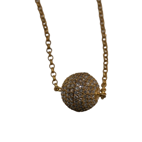 44 - BrooskiContemporaryA pave set diamond ball pendant mounted in gilded silver