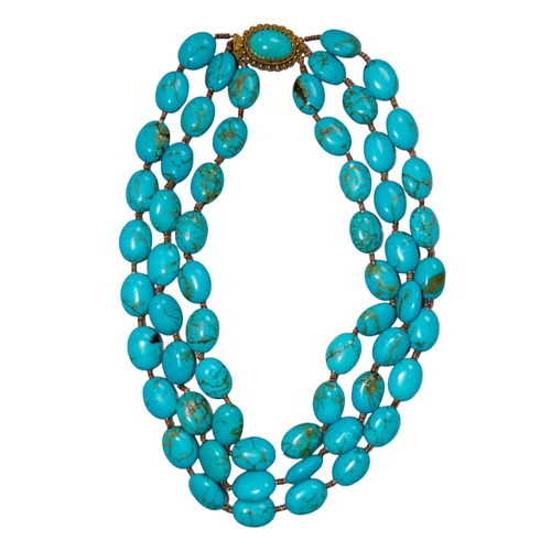 55 - EuropeanCirca 1970 A three-row turquoise bead necklaceFestooned to the front with rows of oval ... 