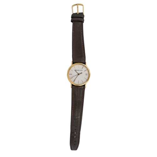 56 - Tiffany and Co.Circa 2000A 14 carat yellow gold gentleman's wristwatchCircular silvered dial with da... 