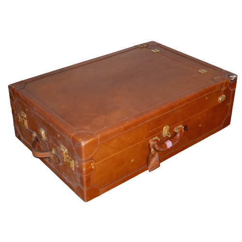 73 - Continental20th CenturyA leather trunk on wheelsDimensions:32 in. (H) x 21 in. (W)... 