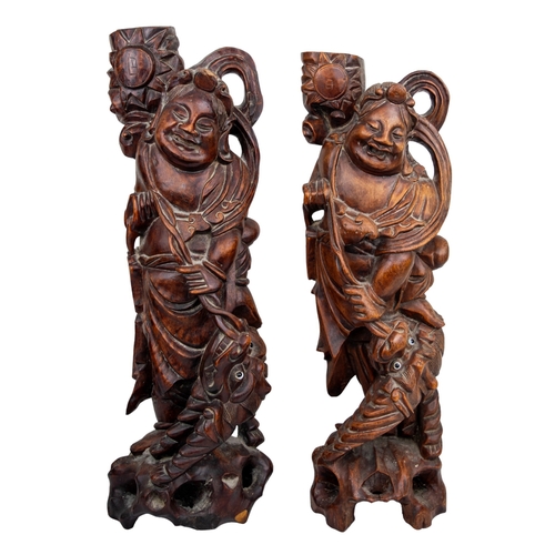 508 - Chinesec.1900A pair of hardwood figures and dragons, with glass inset eyesDimensions:... 