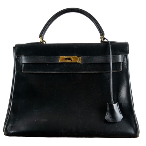 75A - Hermes black Kelly Bag and dust jacketCirca 1970With the original Hèrmes cotton drawstring dust bag ... 