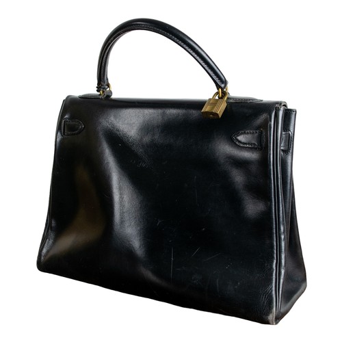 75A - Hermes black Kelly Bag and dust jacketCirca 1970With the original Hèrmes cotton drawstring dust bag ... 