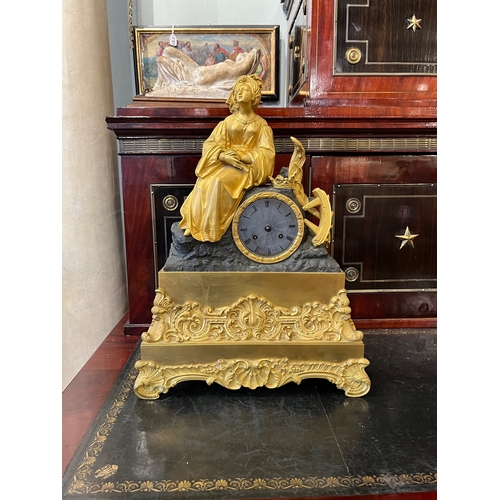 482 - ContinentalCirca 1850A bronze and ormolu mantel clock with St. Catherine of Alexandria martyred with... 