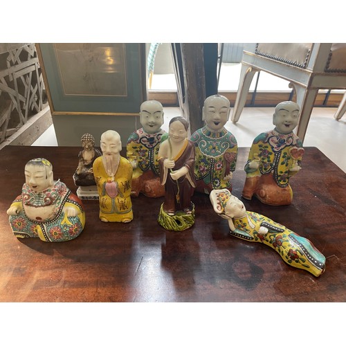 508A - Eight Chinese figuresTo include[a] Three seated laughing monk figures[b] One figure of a reclining l... 