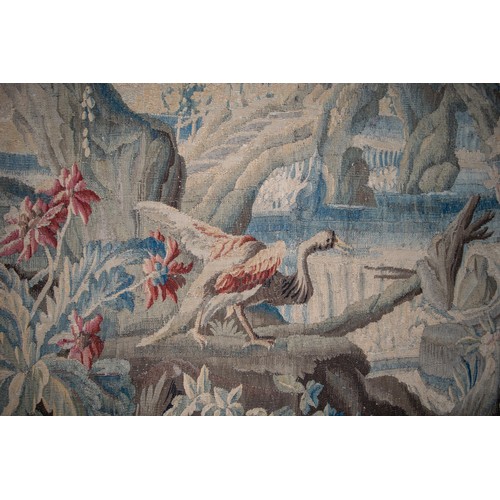 291 - FrenchEarly 18th CenturyA large verdure chinoiserie Aubusson tapestryWith an exotic bird in a river ... 