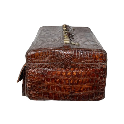 660A - 20th CenturyA crocodile leather vanity travel case with silver engraved and cut rock crystal persona... 