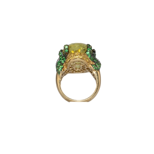 14 - ContinentalContemporaryA diamond, tsavorite garnet and lemon quartz dress ringThe oval briolette cut... 