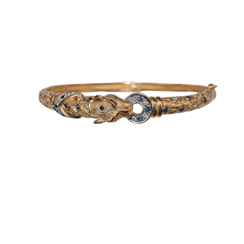 17 - ContinentalCirca 1980A 9 carat yellow gold, diamond and sapphire set leopard torc bangleThe head and... 