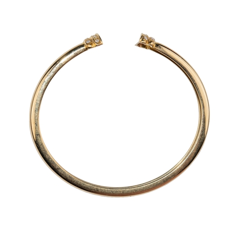 26 - ContinentalCirca 1990A pair of 18 carat gold and diamond torc banglesThe plain flexible bangles set ... 