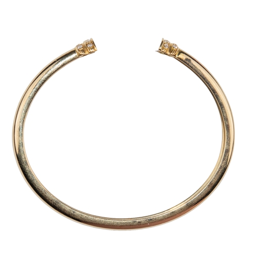 26 - ContinentalCirca 1990A pair of 18 carat gold and diamond torc banglesThe plain flexible bangles set ... 