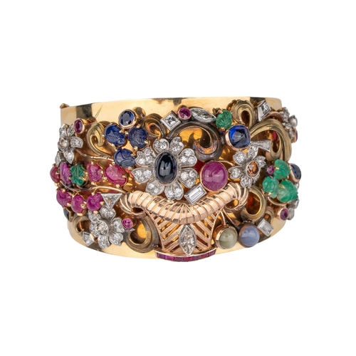 43 - ContinentalArt Deco Circa 1935A striking multi-gem set giardinetto bangleThe wide bangle applied wit... 