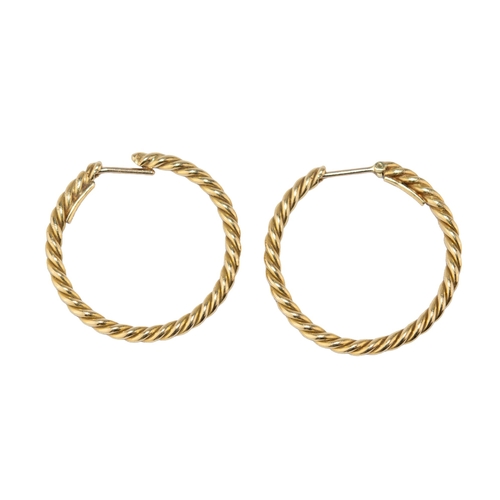 47 - CartierLondonCirca 1977A pair of 18 carat gold hoop earringsWeight: Approx. 6.97 gramsDimensions: 2.... 